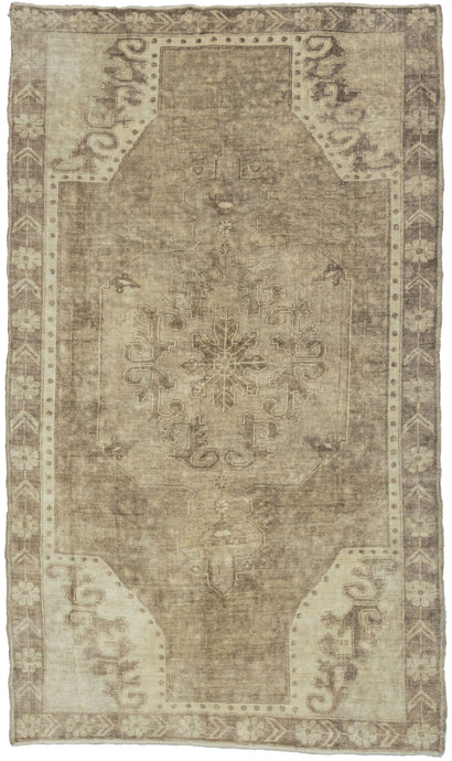This Vintage Anatolian Rug features a central medallion on an open field with four cornices. The ornate patterning is softened by the limited palette of beiges and browns. Soft tones and limited contrast make this a very easy rug to decorate around.