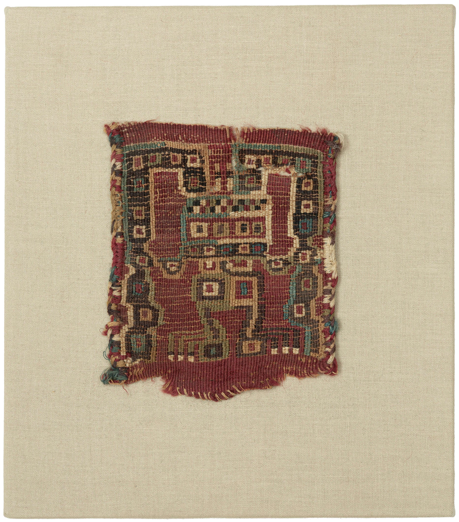 This Pre-Columbian tapestry fragment dates to the Wari period (circa 600–1000 AD) and showcases the intricate geometric abstraction that defined the visual language of the Middle Horizon Andes.

The design, executed in a fine tapestry weave, depicts a highly abstracted anthropomorphic figure with extended, angular limbs which is likely a shaman or ritual intermediary. Rendered in cochineal red, deep indigo, green, and cream, the figure exemplifies the Wari use of bold color and geometry to convey spiritual 