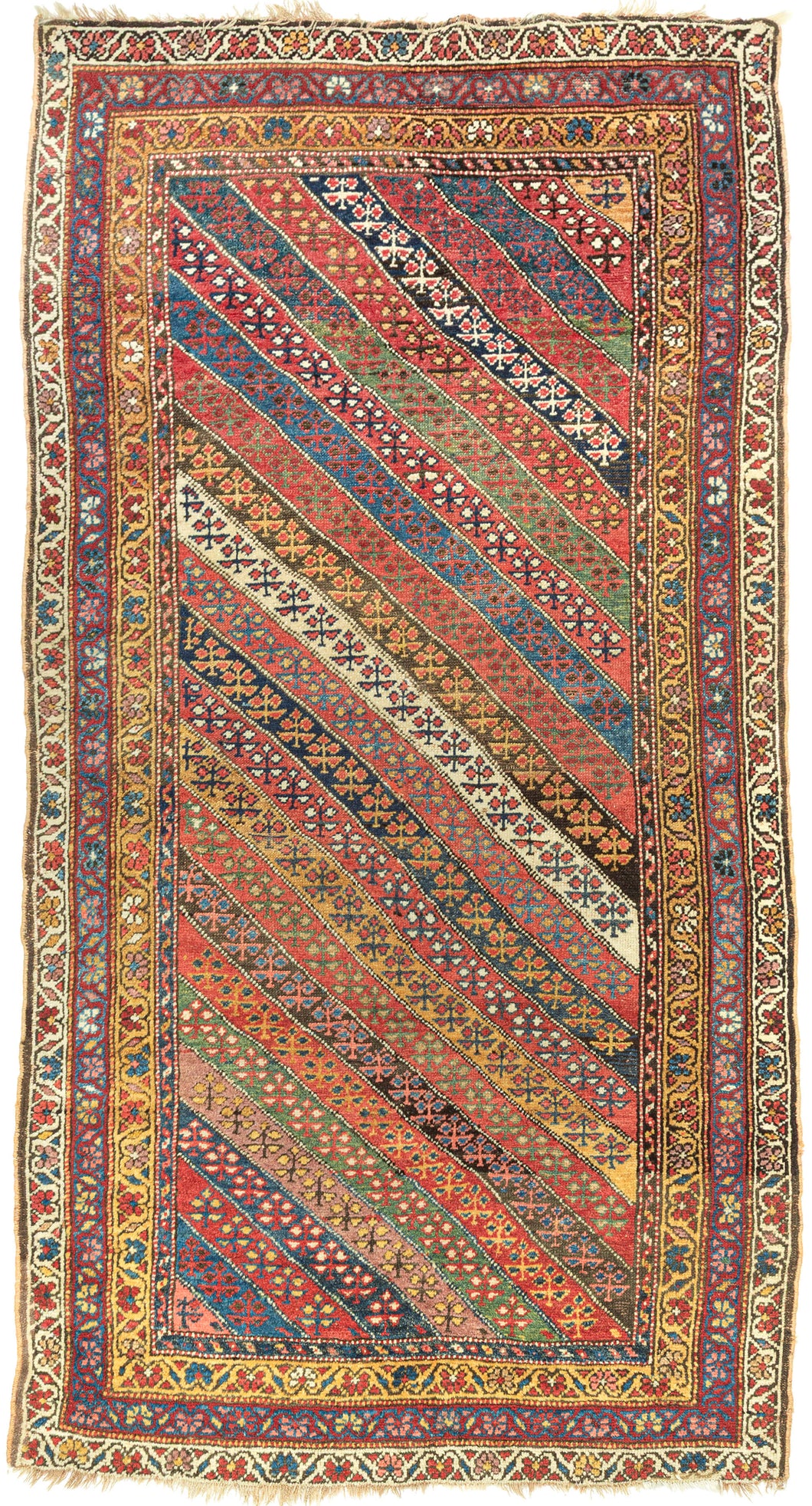 An exceptional Kurdish rug distinguished above all by its top-notch color and superb wool. The field is composed of lively diagonal bands, each carrying a different floral or geometric repeat and shifting through saturated brick red, deep indigo, grassy green, ivory, ochre, aubergine, and soft rose.