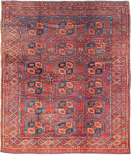 A handsome Ersari Turkmen carpet with a richly saturated madder-red field organized into rows of large octagonal guls, each quartered and filled with small floral devices. Between them, angular cruciform ornaments create a secondary lattice, giving the field an unusually energetic rhythm.