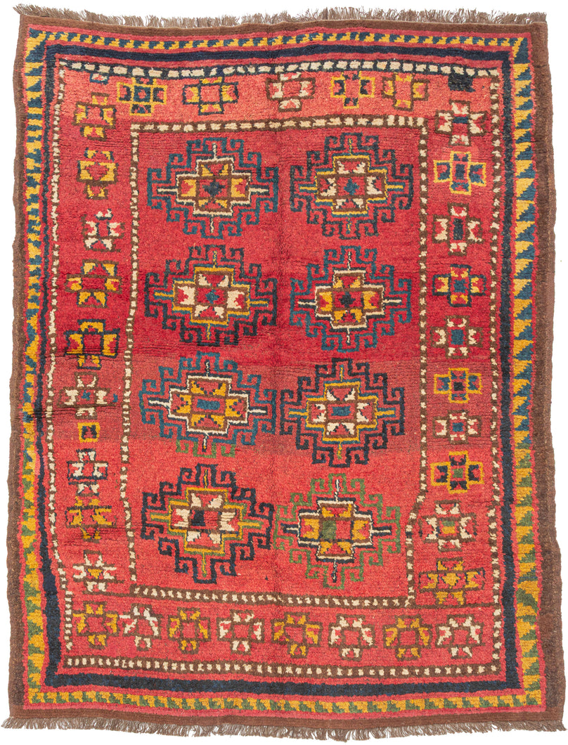 This Kurdish Yatak was handwoven in Eastern Anatolia during the late 19th century.

A vibrant and expressive Kurdish Anatolian Yatak, woven in the highland villages of Eastern Anatolia and originally intended as a sleeping or bedding rug. The format is classic with a warm, saturated red field filled with a rhythmic repeat of memling guls outlined in deep indigo and enlivened with saffron, ivory, moss green, and brick tones. The drawing is bold and spontaneous, full of angular hooked outlines and charming tr