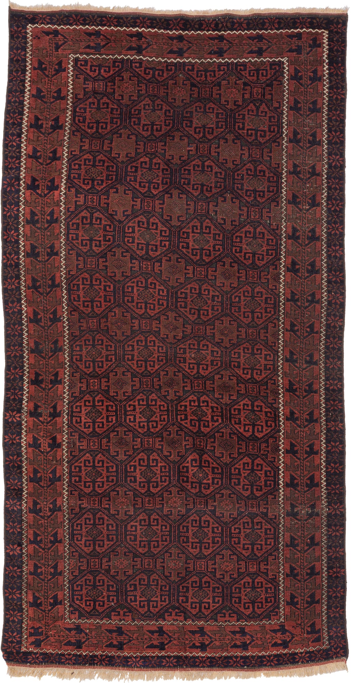 A richly patterned Baluch rug with a dense, all-over field of octagonal guls, each filled with intricate, angular motifs. The repeating geometry creates a rhythmic, almost textile-like surface, framed by multiple borders with stylized elements that echo the structure of the field.

Woven in the late 19th to early 20th century, the palette is grounded in deep madder reds and soft abrashed browns, offset by dark indigo outlines. The dyes have mellowed beautifully over time, giving the rug a warm, cohesive ton