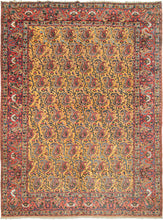This Bakhtiari rug was handwoven during the second quarter of the 20th century.   It features an allover design of scrolling vines with blossoming botehs in tones of red, blue, green, coral, ivory, and a spectacular amber yellow that completely steals the show. Framed by the main border of pairs of more so-called "mother-daughter" or 'pregnant" botehs alternating with ivory palmettes on the patinated red ground.