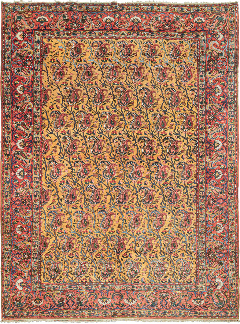 This Bakhtiari rug was handwoven during the second quarter of the 20th century.   It features an allover design of scrolling vines with blossoming botehs in tones of red, blue, green, coral, ivory, and a spectacular amber yellow that completely steals the show. Framed by the main border of pairs of more so-called 