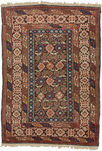 A finely woven Chi-Chi rug from the northeastern Caucasus, packed with the dense, jewel-like drawing for which the group is prized. The dark chocolate-brown field is organized in horizontal bands of stepped geometric medallions alternating with tightly worked floral and abstract devices in saturated cobalt blue, brick red, ivory, soft green, and apricot.
