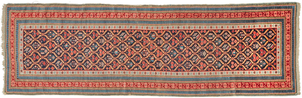 An exceptional example of the Seychour tradition, this runner stands out for the clarity of its drawing, crisp geometry, and refined palette. A tightly organized lattice of abstracted floral forms runs the full length of the field, each element articulated with precision and rhythm that feels both deliberate and energetic.