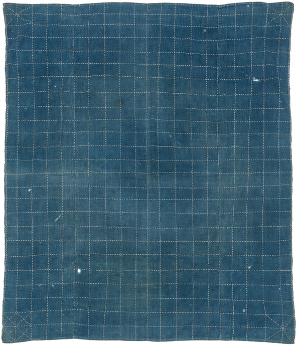 A beautifully simple Japanese wrapping cloth in indigo, featuring an allover grid of hand-stitched sashiko. The soft blue ground is animated by rhythmic white stitching, forming a subtle check pattern with corner reinforcements.