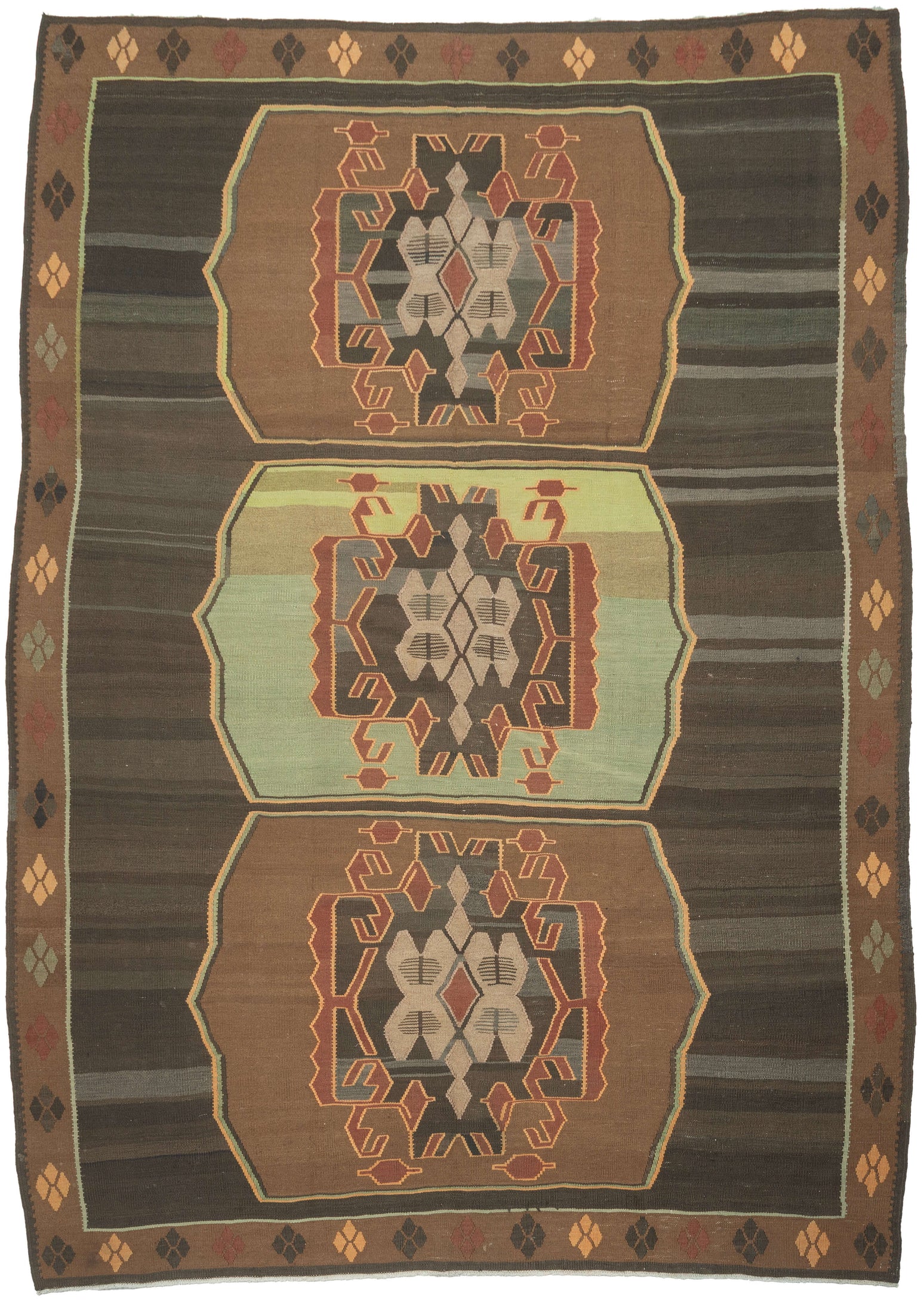 Vintage Kars kilim from eastern Turkey with three geometric medallions in brown and green tones, arranged within an open field with horizontal banding and framed by a border of small repeating diamond motifs.