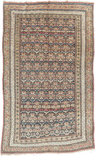 Quchan KURD It features a fine and densely woven lattice of repeating floral motifs in various blues, red, yellow, green, peach, brown and ivory set against an indigo ground. The interconnected patterning and consistent use of color and spacing create a mesmerizing rhythm. Nicely framed by a series of larger borders of shapes and rosettes and thinner simple candy cane stripes in an array of tones