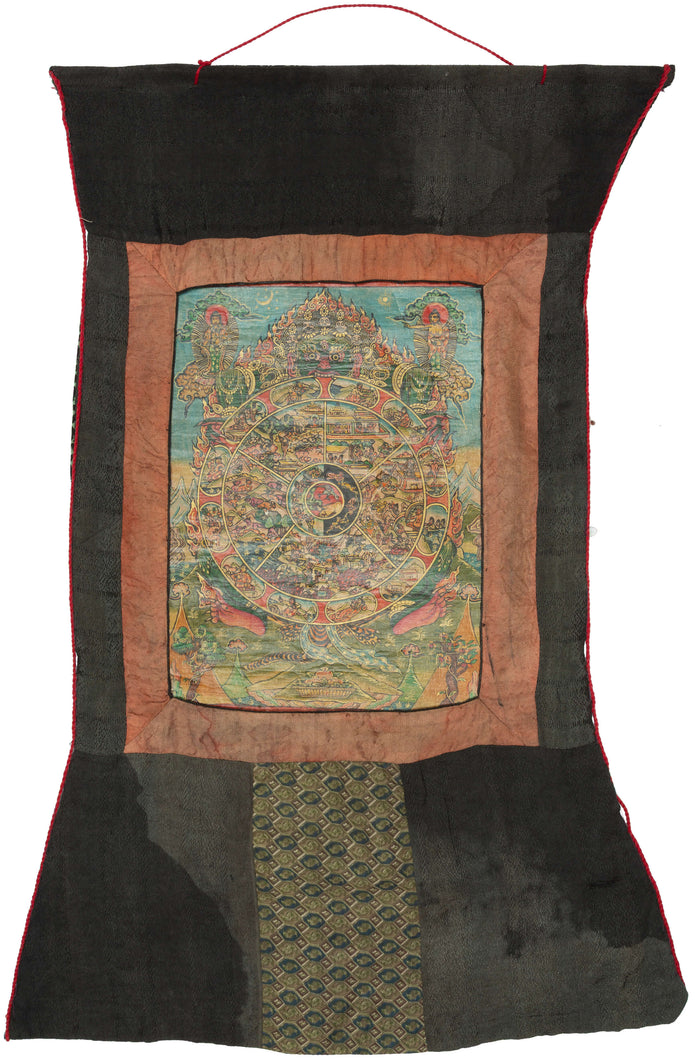 This intricate and vividly painted thangka illustrates the Bhavachakra or the Wheel of Life which a profound visual teaching on the Buddhist understanding of samsara, the endless cycle of birth, death, and rebirth. At the center, the three poisons of ignorance, attachment, and aversion are symbolized by the pig, rooster, and snake. Surrounding them are the six realms of existence, each finely rendered with remarkable narrative detail and expressive color.