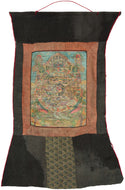This intricate and vividly painted thangka illustrates the Bhavachakra or the Wheel of Life which a profound visual teaching on the Buddhist understanding of samsara, the endless cycle of birth, death, and rebirth. At the center, the three poisons of ignorance, attachment, and aversion are symbolized by the pig, rooster, and snake. Surrounding them are the six realms of existence, each finely rendered with remarkable narrative detail and expressive color.