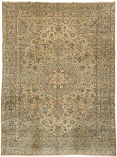 A classic faded Kerman rug with a finely articulated floral field and a soft, balanced palette of warm beige, muted blue, and gentle earth tones. The drawing is intricate yet harmonious, with scrolling vines and rosettes arranged around a calm central medallion that gives the composition focus without heaviness.