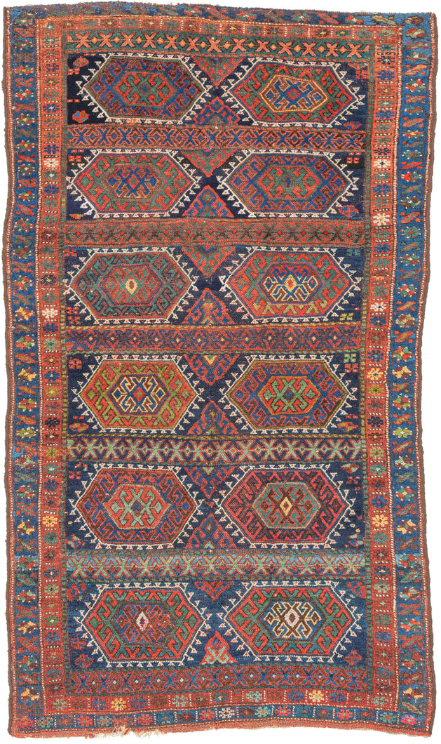 Sanjabi Kurdish rug from western Persia with repeating hexagonal medallions in red, blue, green, and ivory on an indigo ground, with geometric borders.