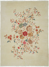 A luminous Chinese Art Deco rug with a spacious ivory field anchored by an asymmetrical flowering tree composition. Soft celadon, coral, blush, and muted gold tones float across the surface, creating an airy, painterly effect against the open ground.