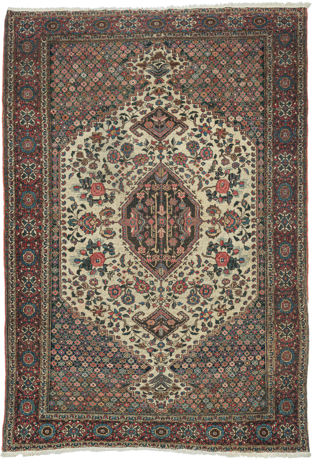 This finely woven Bakhtiari rug is distinguished by its elegant ivory medallion field framed by richly ornamented millefleurs corner spandrels. Graceful vinery and abundant gul farang (“foreign flower”) cabbage roses fill the composition, creating a refined balance between geometric structure and naturalistic floral ornament.