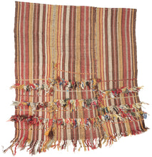 In Anatolian weaving traditions, such additions often carried protective or symbolic meaning. Knotted cords, dangling fibers, and small beads were believed to function as apotropaic elements, intended to ward off the evil eye and protect the household. These expressive embellishments transform the textile from a simple utilitarian weave into a more personal and talismanic object.