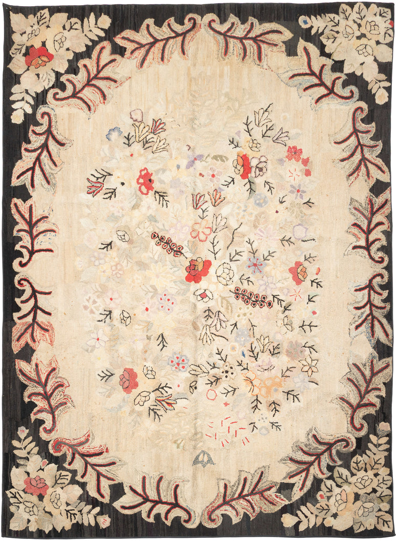 Large early–mid 20th century American hooked rug (8’8” x 11’10”) with a soft ivory floral field in muted pastels, framed by a bold charcoal border with red and cream scrolling vines; from a New Hampshire collection.