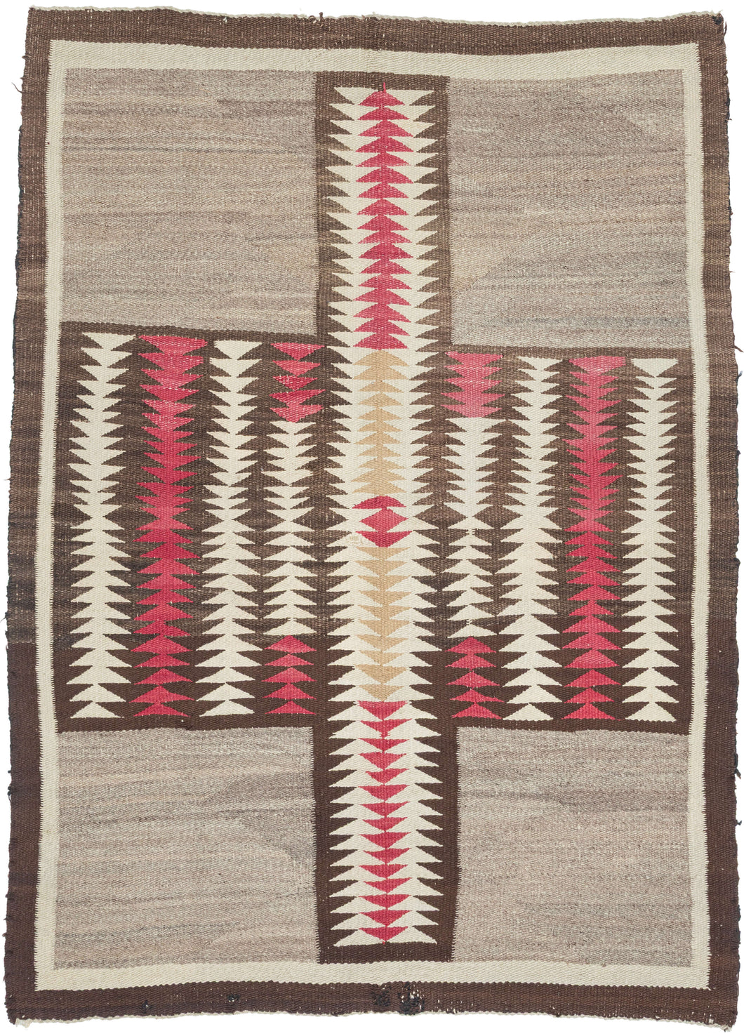 This exceptional vintage Navajo weaving is distinguished by its remarkably bold and unconventional composition. A dramatic abstracted butterfly or cruciform motif anchors the design, its rhythmic serrated forms creating a striking sense of movement while broad expanses of natural gray wool provide a calm, spacious counterpoint. The result is a textile that feels both deeply rooted in tradition and distinctly modern.
