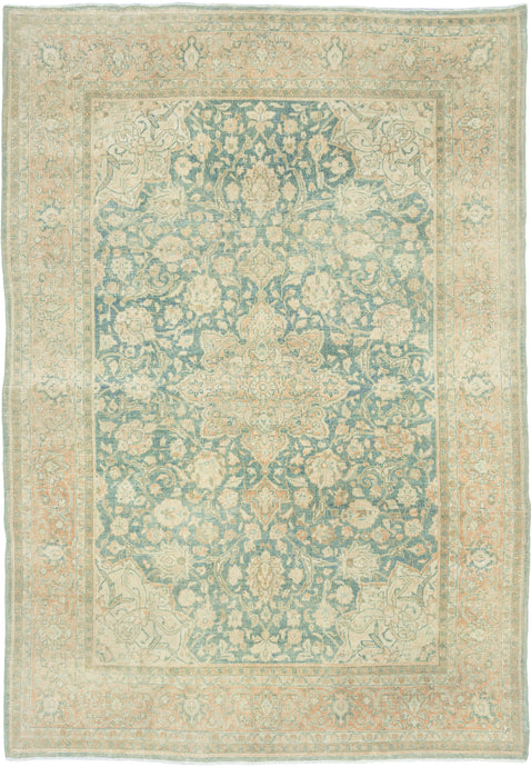It features an ornate all-over design of muted palmettes and floral sprays in various soft shades of caramel, khaki and terracotta on an undulating indigo ground. It is framed by a border of alternating palmettes on meandering vines on a dusty peach ground. Very decorative, a soft, and elegant piece that will subtly elevate any space. washed out tabriz