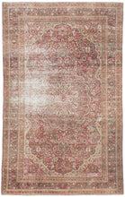 A beautifully timeworn example from the famed workshops of Meshed, this decorative rug exudes character and quiet elegance. The design centers on a soft rosette medallion surrounded by an intricate field of scrolling floral vines and palmettes in tones of rose, ivory, pistachio, and faded turquoise. The allover pattern radiates a sense of harmony and refinement, the hallmarks of Meshed weaving during its classical period.