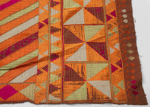 Phulkari is a tradition of folk embroidery from the Punjab region that encompasses both India and Pakistan. It is composed of colorful silken thread atop rough cotton cloth. Bagh is a particular type of Phulkari where the silk embroidery thread completely covers the cotton making the base barely visible. Baghs were often intended to be worn for special events like weddings.&nbsp;

This bagh was crafted in three strips and features a large wonky central diamond full of personality and charm. Framed by a top 