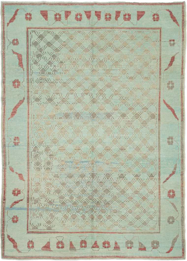 A wonderfully unusual handwoven rug with a soft aqua ground and an intricate allover network of small geometric forms in taupe, gray, and faded blue. The dense central field is surrounded by a much more open border populated with quirky, almost pictographic motifs in brick red and charcoal. 