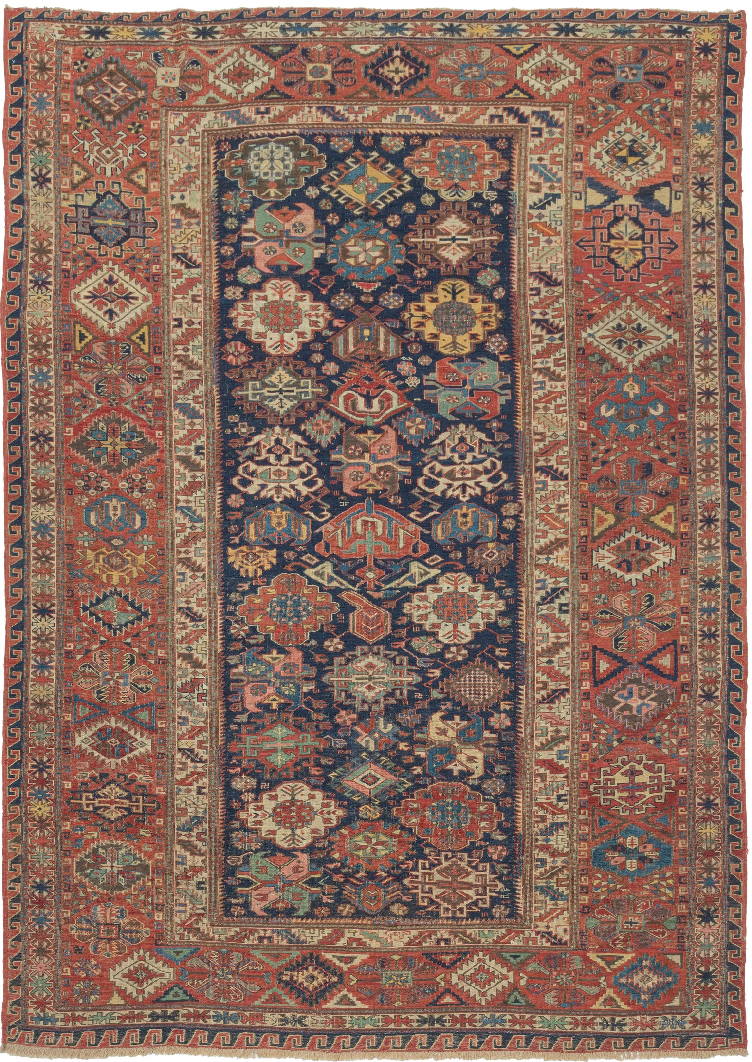 A richly patterned Soumak from the northeastern Caucasus, woven in the 19th century with an unusually varied assortment of boldly drawn floral and geometric forms.

The deep indigo field is densely populated with stylized palmettes, rosettes, blossoms and angular vegetal devices, individually rendered in saturated shades of madder red, blue, green, ivory and golden yellow. The floral vocabulary closely recalls the celebrated Kuba “blossom” rugs, whose fields are similarly animated by large, colorful palmett