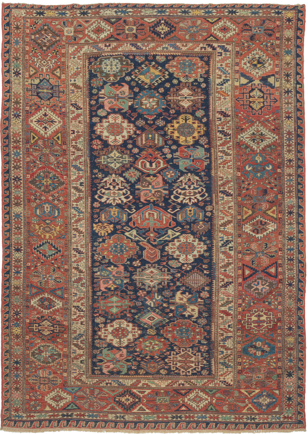 A richly patterned Soumak from the northeastern Caucasus, woven in the 19th century with an unusually varied assortment of boldly drawn floral and geometric forms.

The deep indigo field is densely populated with stylized palmettes, rosettes, blossoms and angular vegetal devices, individually rendered in saturated shades of madder red, blue, green, ivory and golden yellow. The floral vocabulary closely recalls the celebrated Kuba “blossom” rugs, whose fields are similarly animated by large, colorful palmett