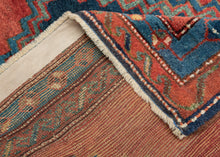This Kazak rug was handwoven in the Southwest Caucasus during the early 20th century.

A striking example featuring three boldly drawn stepped medallions set against a vibrant, glowing red field. The palette is classic Southwest Caucasian: deep indigo, moss green, ivory, and saturated natural reds that radiate warmth and energy. The central medallion really pops and is distinguished by a lovely jewel toned blue green and enhanced by a starkly contrasting ivory outline that giving the piece strong graphic pr