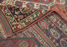 This rug was woven by the Khamseh Confederation during the 19th Century

It features three totemic ivory ground medallions against a rich madder red field and is adorned with a dazzling array of stylized rosettes and abstracted blossoms. It is well balanced by a densely decorated main border of intricate boteh (paisley) motifs. The original blue, green and red striped end kilims are still intact perfectly completing the rug. A good example of this very collectible type.