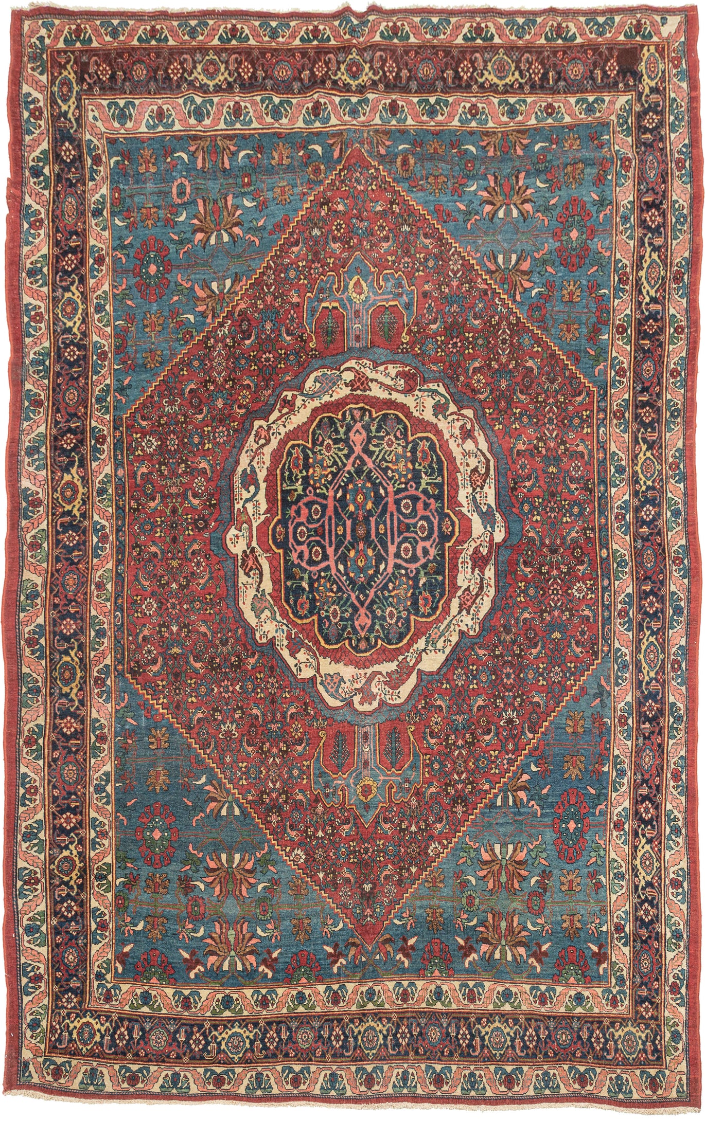 This Bidjar rug was handwoven during the late 19th century.

It features a central medallion, framed by a ivory cartouche that radiates against a dense rose-red field enriched with finely detailed herati motifs and corner spandrels in sapphire blue. The surrounding field bursts into cool cerulean, where stylized palmettes, rosettes, and floral sprays create a sense of celestial order. A series of robust borders—anchored by a deep indigo ground and flanked by meandering boteh and palmette guards—grounds the 