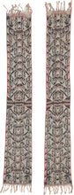 A striking West Timor cotton ikat featuring rhythmic ancestral and vegetal motifs arranged in a vertical progression. Deep brown-black and soft ivory form the primary contrast, accented by subtle coral and indigo details that animate the surface.

The repeating abstracted figural forms and branching motifs reflect Timorese ceremonial weaving traditions, executed in warp ikat with characteristic feathered edges. Finished with traditional fringe and side bindings.