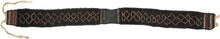 A striking Baluch animal trapping, woven in a long, narrow format with its original braided ties still attached. The design is spare and powerful with a dark wool ground animated by a chain of ivory stepped motifs, small flashes of madder red, and compact end panels with orange and ivory geometric borders.