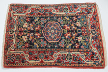 A finely drawn Jozan rug with a deep midnight-blue field filled with scrolling vines, palmettes, and delicate floral motifs surrounding a compact central medallion. The lively botanical design unfolds symmetrically across the field, framed by a richly ornamented red border populated with stylized blossoms and curling tendrils.