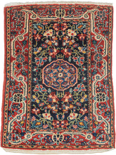 A finely drawn Jozan rug with a deep midnight-blue field filled with scrolling vines, palmettes, and delicate floral motifs surrounding a compact central medallion. The lively botanical design unfolds symmetrically across the field, framed by a richly ornamented red border populated with stylized blossoms and curling tendrils.