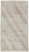 A beautifully washed Konya rug with a softly muted field and understated geometric patterning. Pale celadon, blush, and lavender tones drift across the surface, creating a gentle, watercolor-like effect.&nbsp;The classic stepped Seljuk design remains visible beneath the patina, providing quiet structure without visual weight.