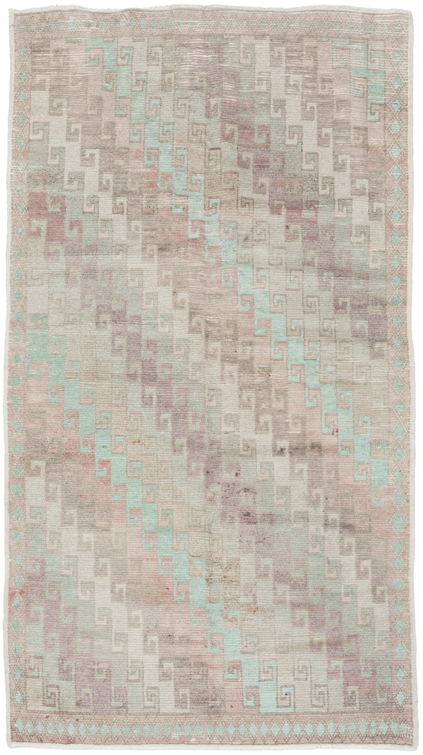 A beautifully washed Konya rug with a softly muted field and understated geometric patterning. Pale celadon, blush, and lavender tones drift across the surface, creating a gentle, watercolor-like effect.&nbsp;The classic stepped Seljuk design remains visible beneath the patina, providing quiet structure without visual weight.