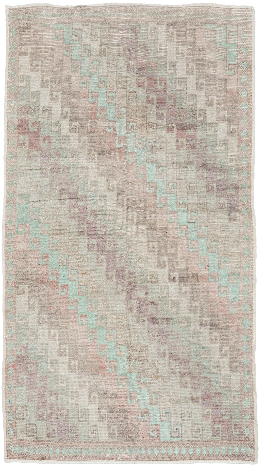 A beautifully washed Konya rug with a softly muted field and understated geometric patterning. Pale celadon, blush, and lavender tones drift across the surface, creating a gentle, watercolor-like effect.&nbsp;The classic stepped Seljuk design remains visible beneath the patina, providing quiet structure without visual weight.