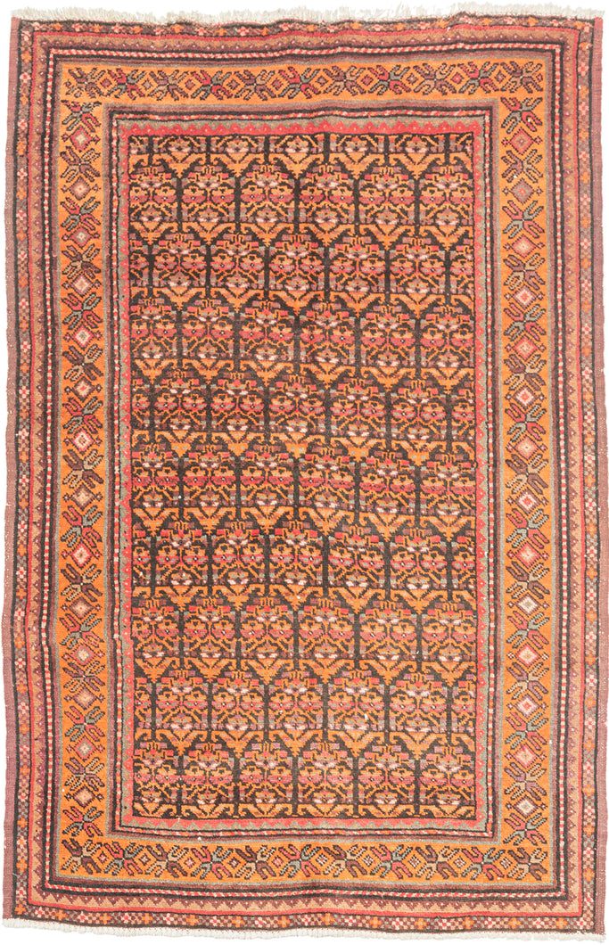 This rug was handwoven by the Kurdish weavers of Kolyai during the middle of the 20th century.

It features an all over design of abstracted floral motifs. In an uncommon and perfectly patinated palette of terracotta, aubergine, watermelon, teal and charcoal. With an enduring elegance that makes it equally suited for both eclectic interiors or more classic settings.