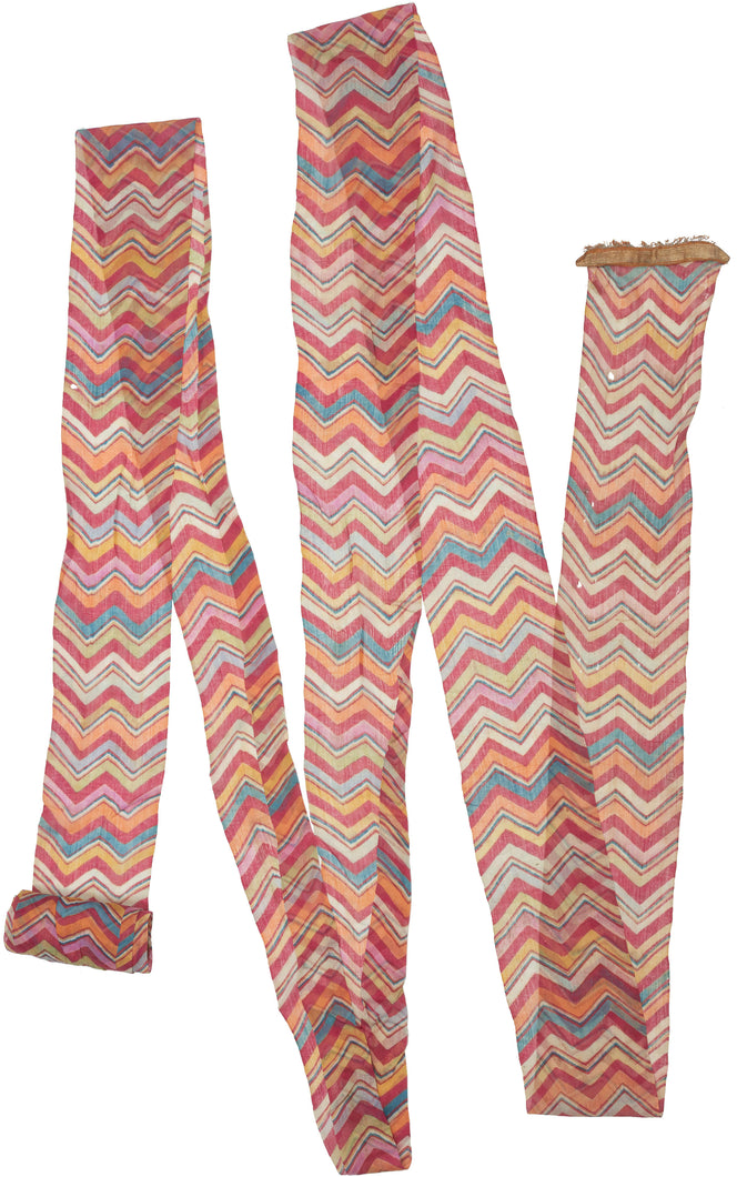 Antique tie-dyed Turban handmade in Rajasthan, India during the early 20th century.

This turban is made of woven muslin cloth, which has been resist-dyed in a multicolored leheriya pattern. Leheriya, which translates to 