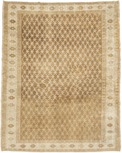 KURD Its warm camel field is animated by a playfully wonky interlocking lattice and framed by a border of larger floral medallions in soft ivory and beige. The lattice has the feel of a bent and distorted chain link fence. The delightful irregularity in the design has an endearing quality that speaks to its handmade nature and gives the piece a unique, almost whimsical character. The washed out neutral palette and subtle abrash create a natural warmth, making it a versatile choice for both traditional