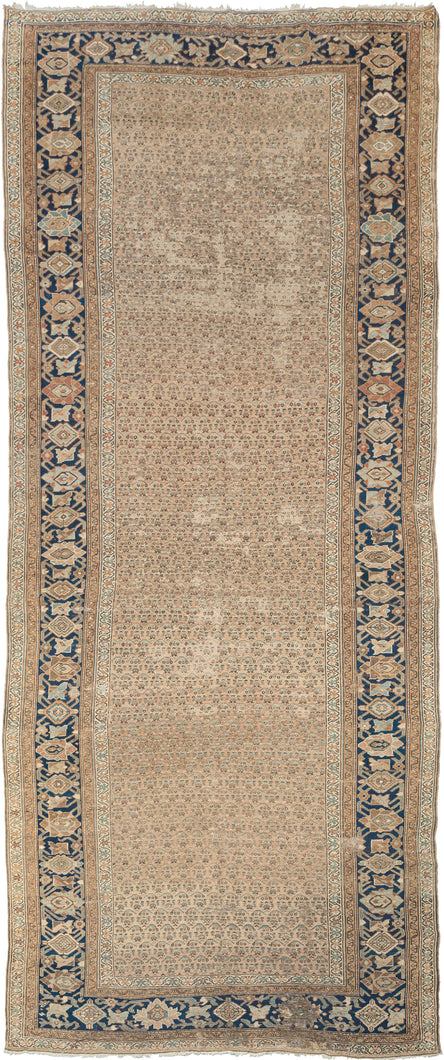 This Malayer runner was handwoven during the second quarter of 20th century.

This washed out wide runner features a repeat pattern abstracted botehs that blend right into one another on the soft and calming camel ground. Framed by a crisp border of palmettes in caramel, soft blues, earthy reds and burnt orange on a deep navy ground.  