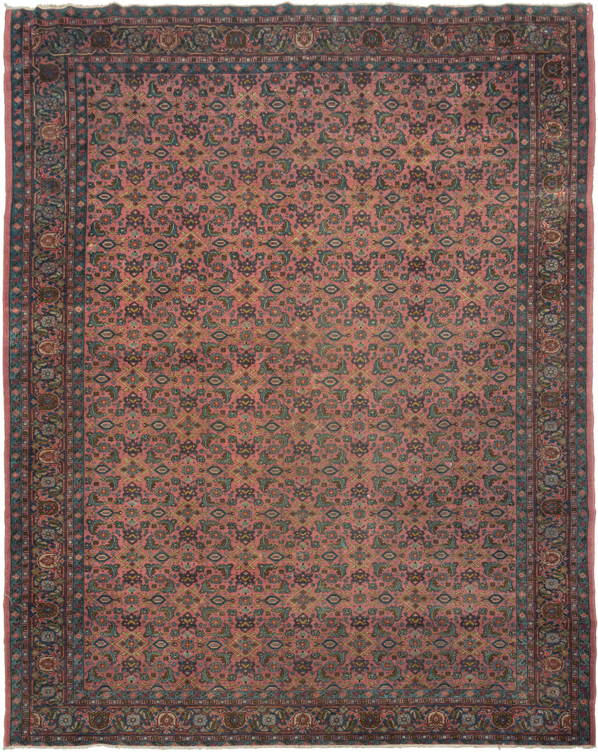 This Sparta rug was handwoven during the middle of the 20th century in Western Anatolia.

It showcases an all over Herati design floral lattice with playful rosettes and curling vinery set against a fun watermelon ground. The rest of the palette blends soft blues, mossy greens and golden accents to create a midcentury vibe. 