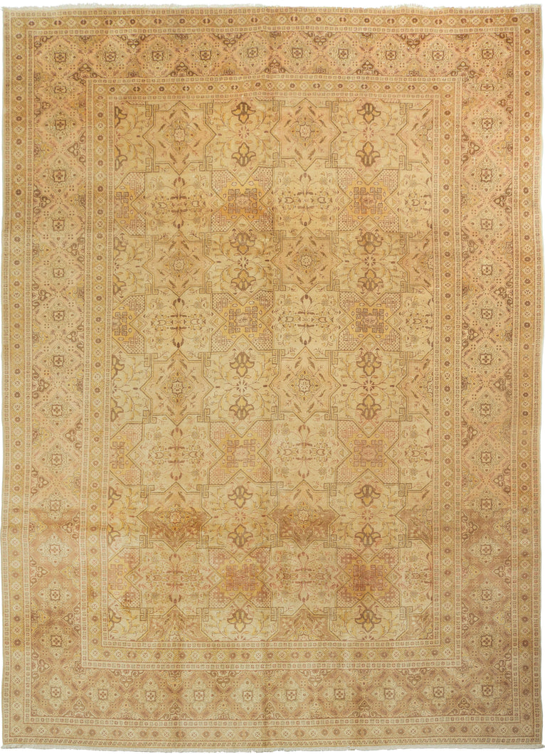 An elegant mid-20th-century Tabriz carpet distinguished by its intricate allover design and softly washed palette.

The field is organized as a continuous lattice of interlocking angular compartments, alternating with floral medallions, palmettes and smaller geometric devices. The tightly fitted shapes create an almost tessellated rhythm across the surface, balancing strong architectural structure with delicate vegetal drawing.