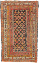 This Kurdish rug was handwoven during the middle of the 20th century.

It features an all-over design of latch hooked diamonds that sparkle against a deep brown/ almost black ground. Framed by a series of border in an uncommon palette of yellows, oranges, pinks and ivory.