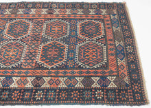 Sanjabi Kurd features a field of graphic hexagons filled with stylized protection symbols in handsome tones of blues, reds, aubergine and ivory on a deep navy ground. Each pair of hexagons is neatly separated by bands of geometric shapes. Well executed patterning that is very refined for type. Each of the three borders accentuate and balance the tones in the composition. Of particular not is the main ivory ground border which adds just the right amount of brightness