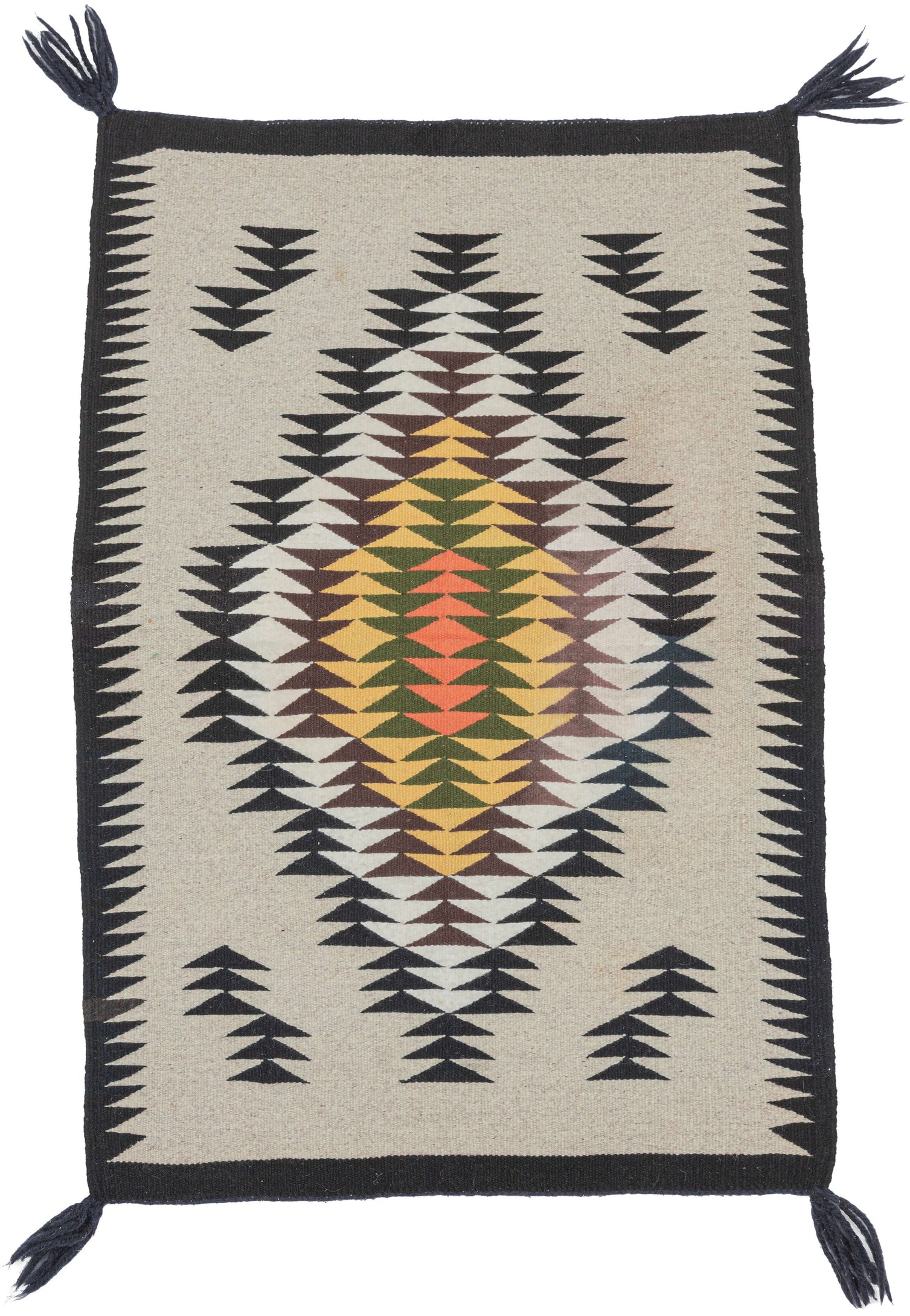 A finely woven vintage Navajo rug with a crisp geometric composition on a natural ivory field. The design centers on a large serrated diamond medallion built from repeating stepped arrow forms in black, white, brown, yellow, green, and salmon.