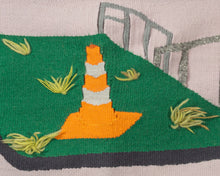 a grassy island with daffodils and a traffic cone - Sophia DeJesus-Sabella