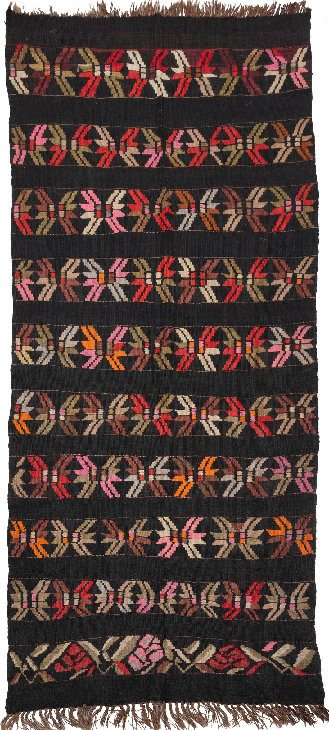 This Karabaugh kilim features horizontal row of stars or abstracted flowers in light and dark brown, soft greens, slate and vibrant red and orange on a black ground. The pattern is simple but interesting and can be read multiple depending on what the viewer focuses on. Woven of hearty handspun with the undyed brown warps adding an additional aesthetic dimension.