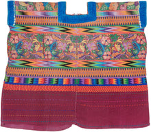 This spectacular Huipil is alive with symbolism and saturated color. The brocaded upper panel features a lush tableau of birds, flowers, and brilliantly woven fish, each motif carrying deep resonance in Maya tradition. Birds evoke freedom and the sky, flowers embody fertility and beauty, and fish symbolize life’s connection to water and abundance.

